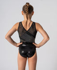 Carica l'immagine nel visualizzatore della galleria, Back view of a young girl in a black leotard with a shimmering design