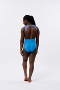 Carica l'immagine nel visualizzatore della galleria, Dancer in a blue and purple leotard from the back
