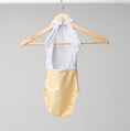 Load image into Gallery viewer, The back of the Felicity leotard hanging on a wooden hanger
