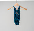 Load image into Gallery viewer, The back of the Jayda leotard hanging on a wooden hanger
