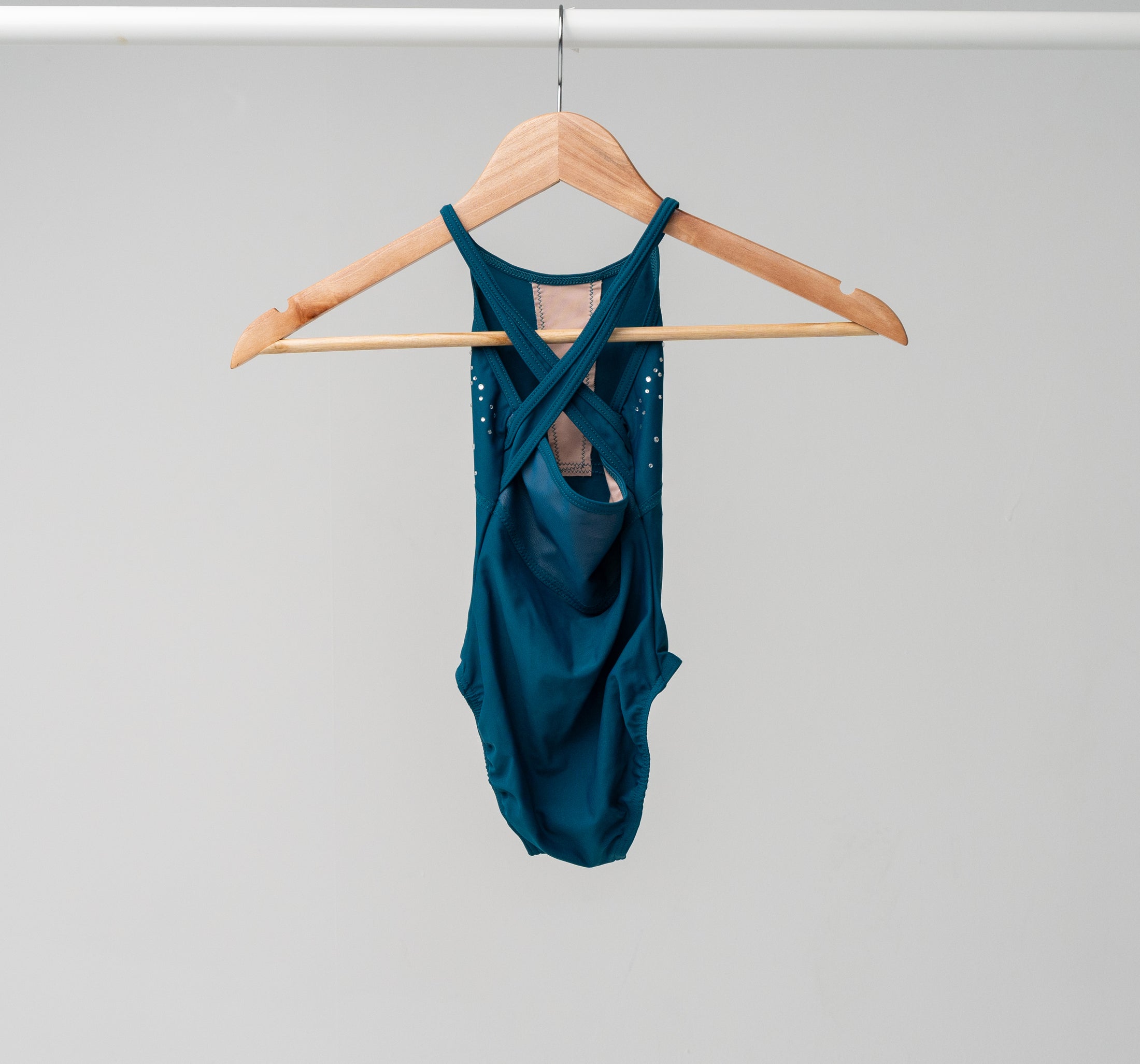 The back of the Jayda leotard hanging on a wooden hanger