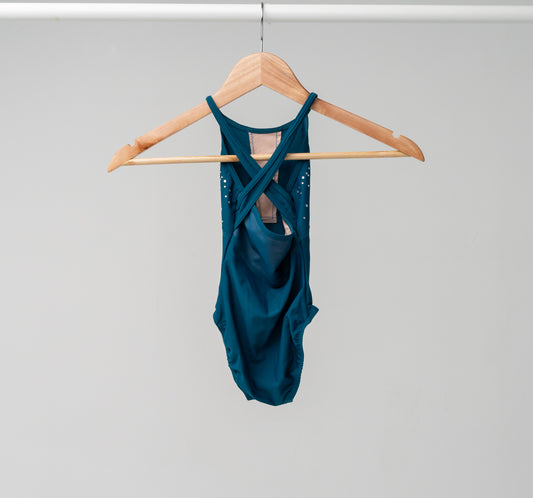 The back of the Jayda leotard hanging on a wooden hanger