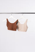 Two sports bras hanging